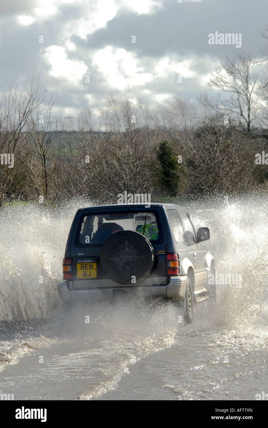 Mitsubishi Pajero shogun driving through flood on a rural road in england Stock Photo