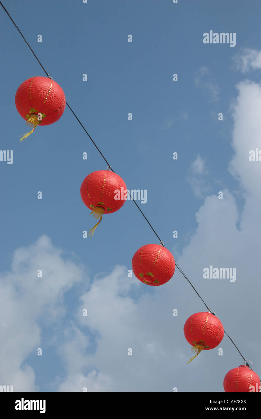 red lanterns hanging in mid air against blue sky Stock Photo - Alamy