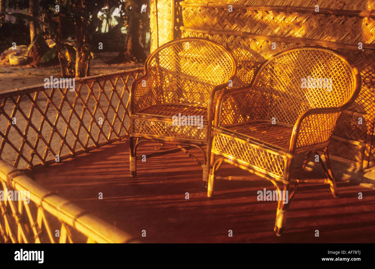 Wicker chairs on a sunlight balcony Stock Photo Alamy