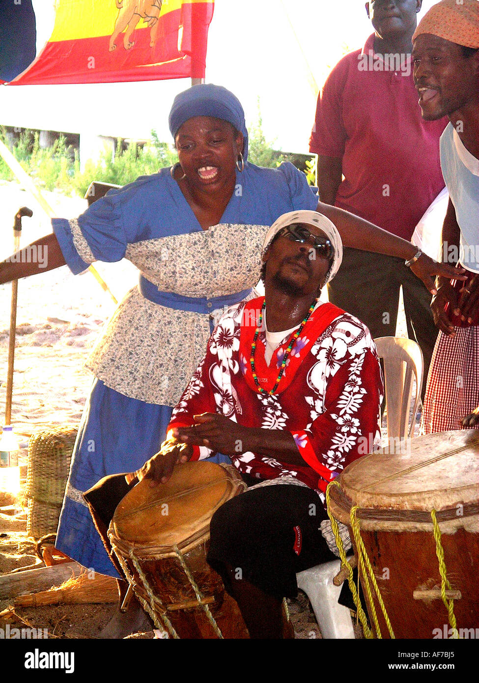 Belize. Street musicians playing drums with woman singing. Stock Photo