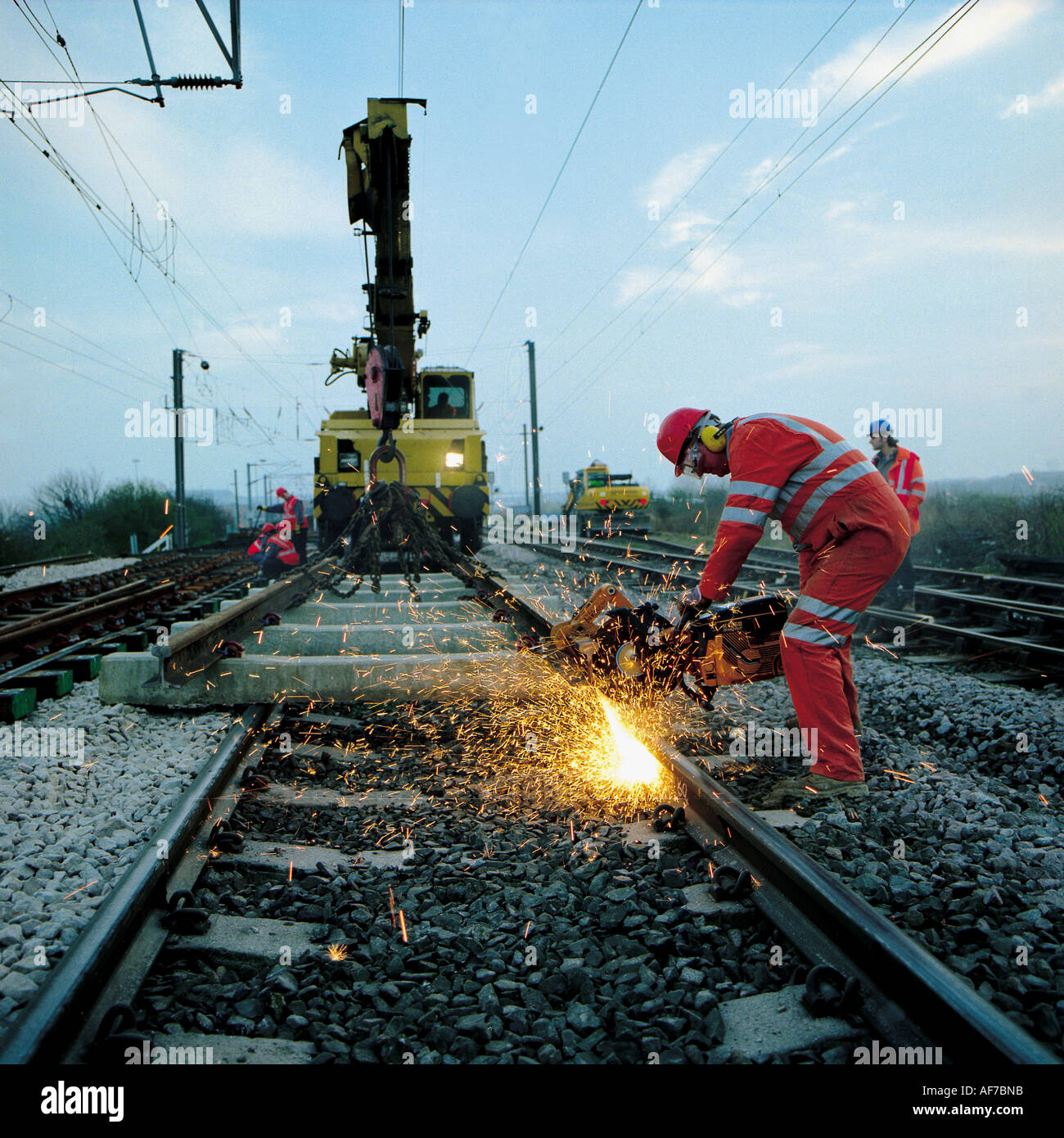 Railway track maintenance team welding rail section. Stock Photo
