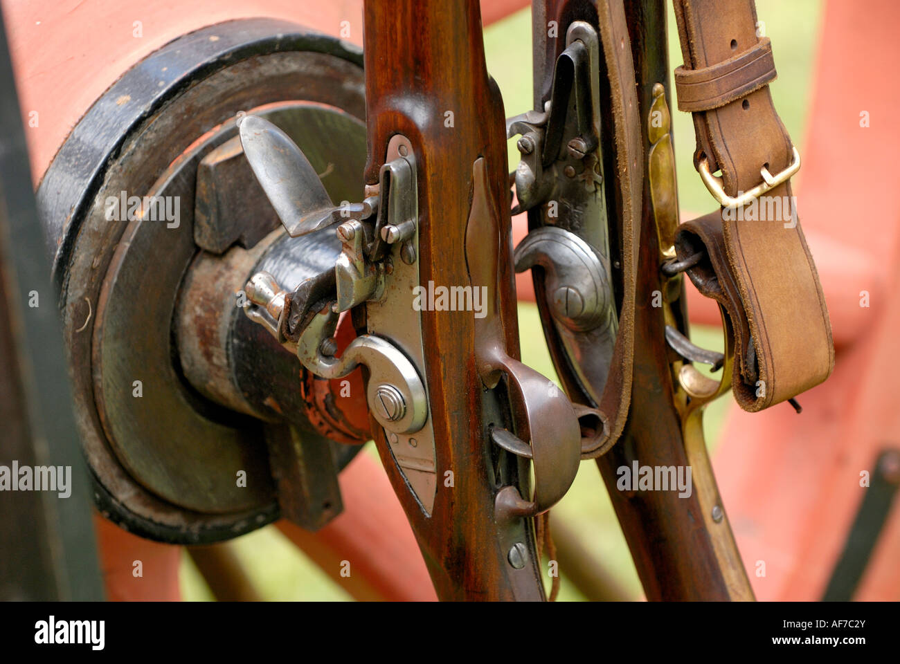 flintlock guns resting against a wheel Stock Photo