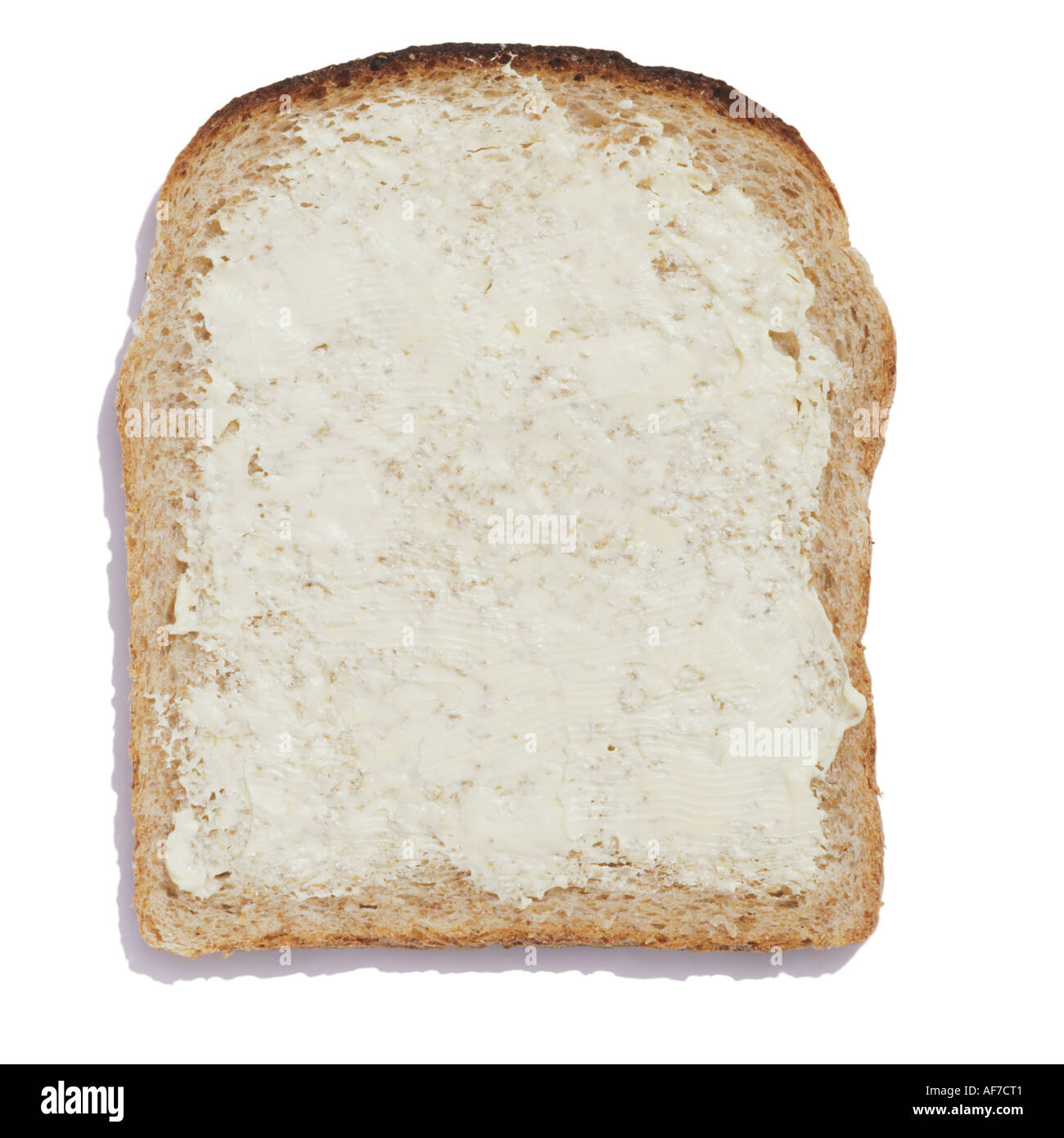 A buttered slice of wholemeal bread Stock Photo