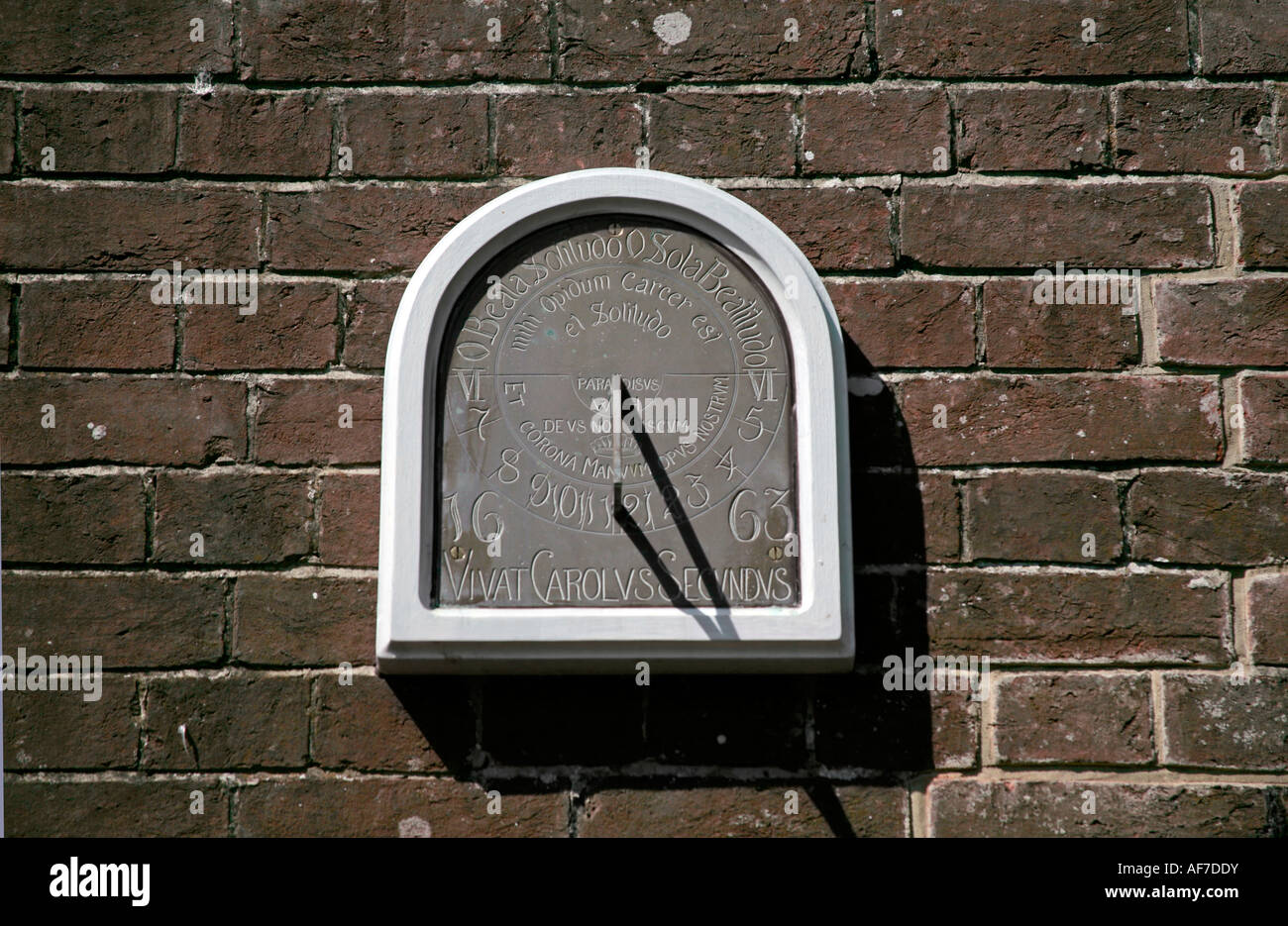 Sundial mounted on red brick garden wall at St Marys House, Bramber