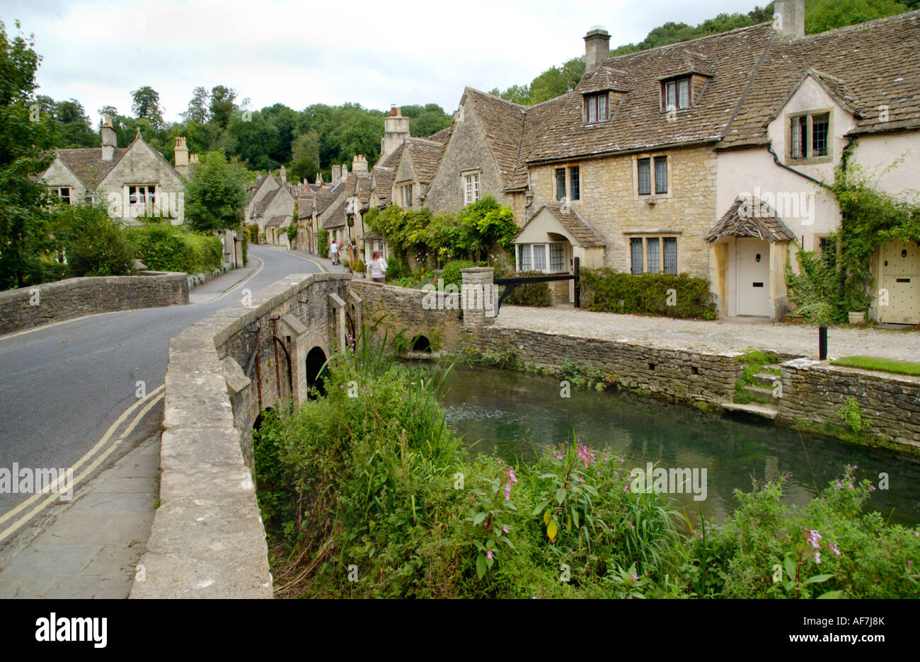 Traditional Cotswold terraced cottages in Castle Combe Wiltshire England UK next to Bybrook stream Stock Photo