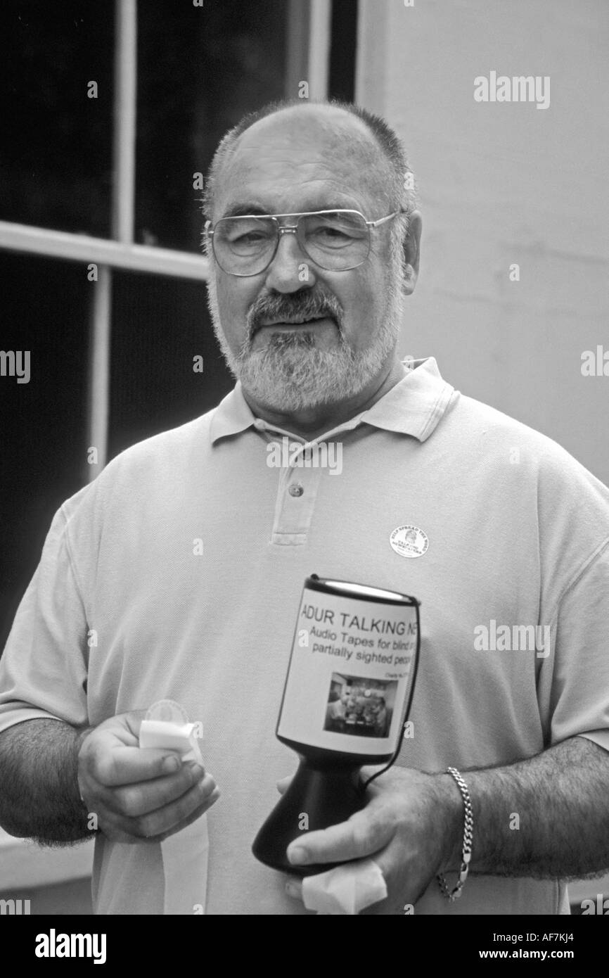 elderly man street collecting for Adur Talking Newspaper a charity for