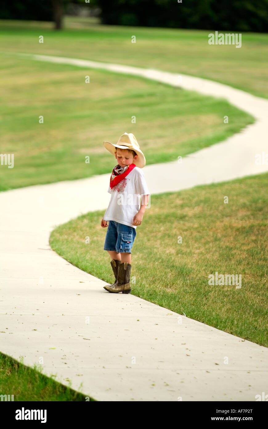5 yr old Austin playing cowboy at the park Stock Photo