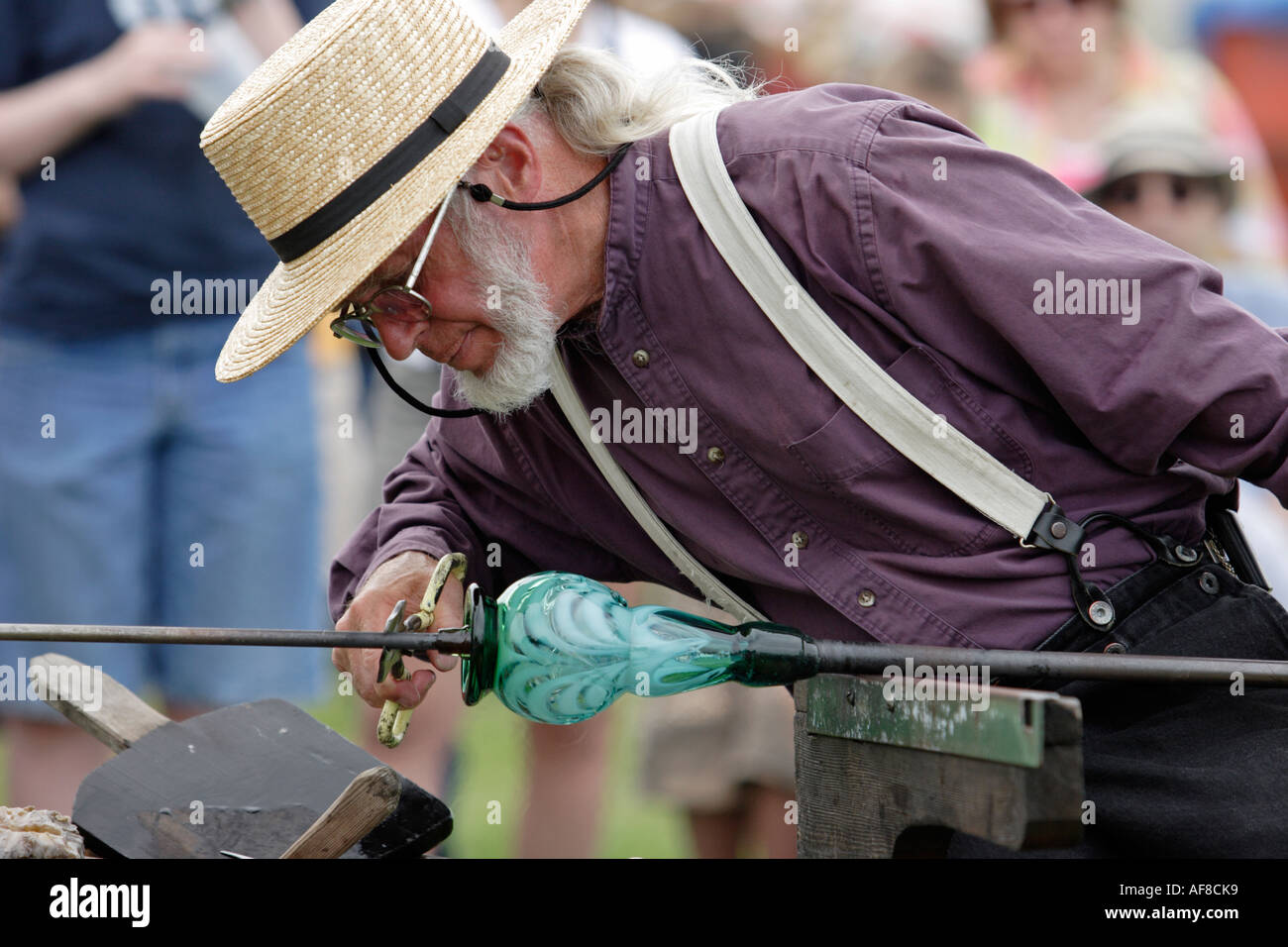 Glass blower makes some adjustments Stock Photo Alamy