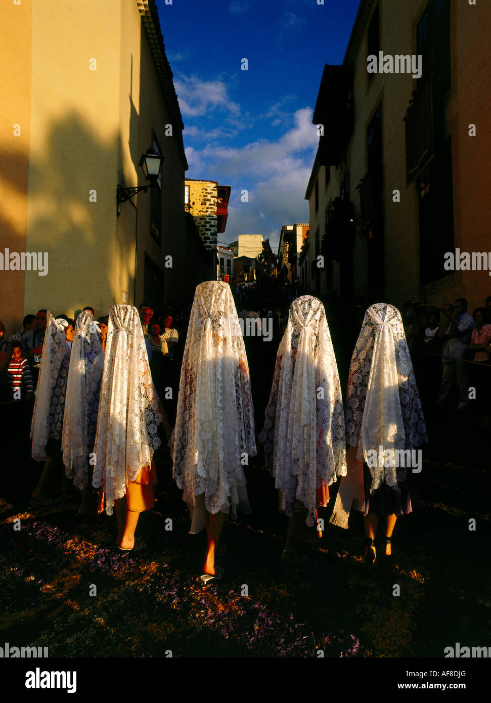 Ladies with mantillas, lace scarfs, traditional headcovering, procession on floral carpets, old town of La Orotava, Tenerife, Ca Stock Photo