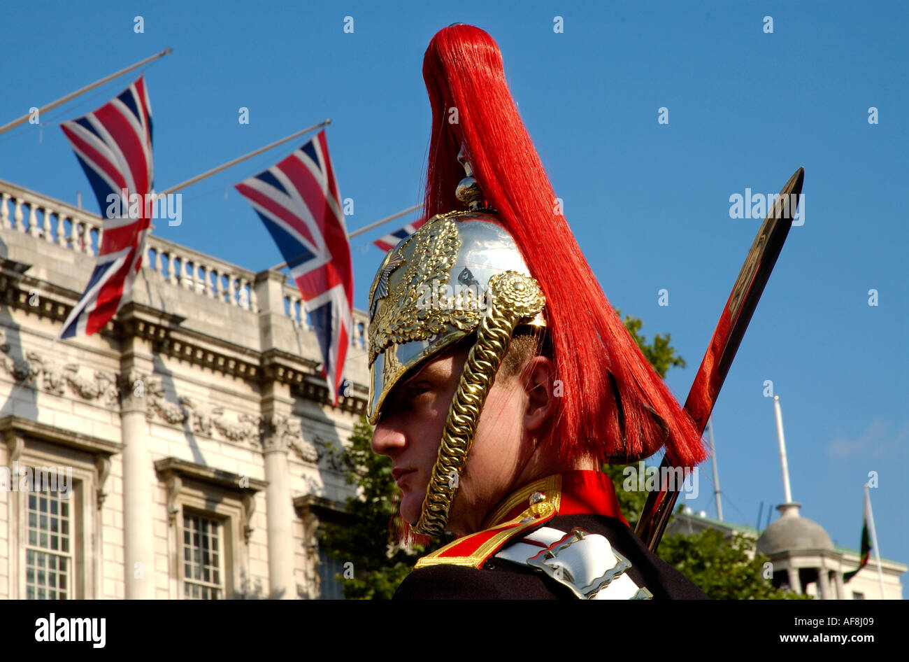 Horseguard soldier in London with union jack flags in the background Stock Photo