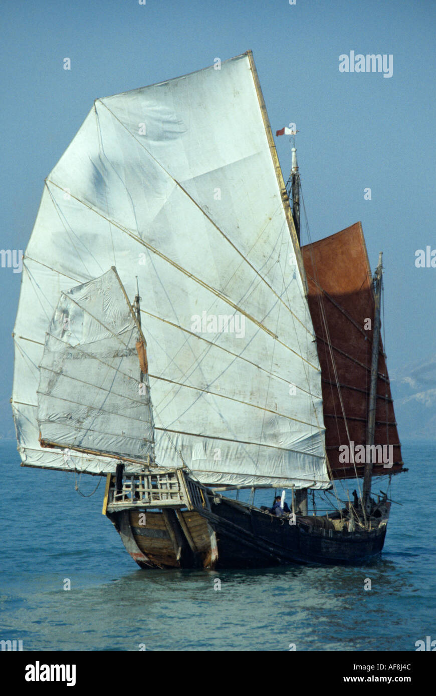 Stern view of a traditional genuine old local sailing junk in the late 1970s in Victoria Harbour Hong Kong Island Stock Photo