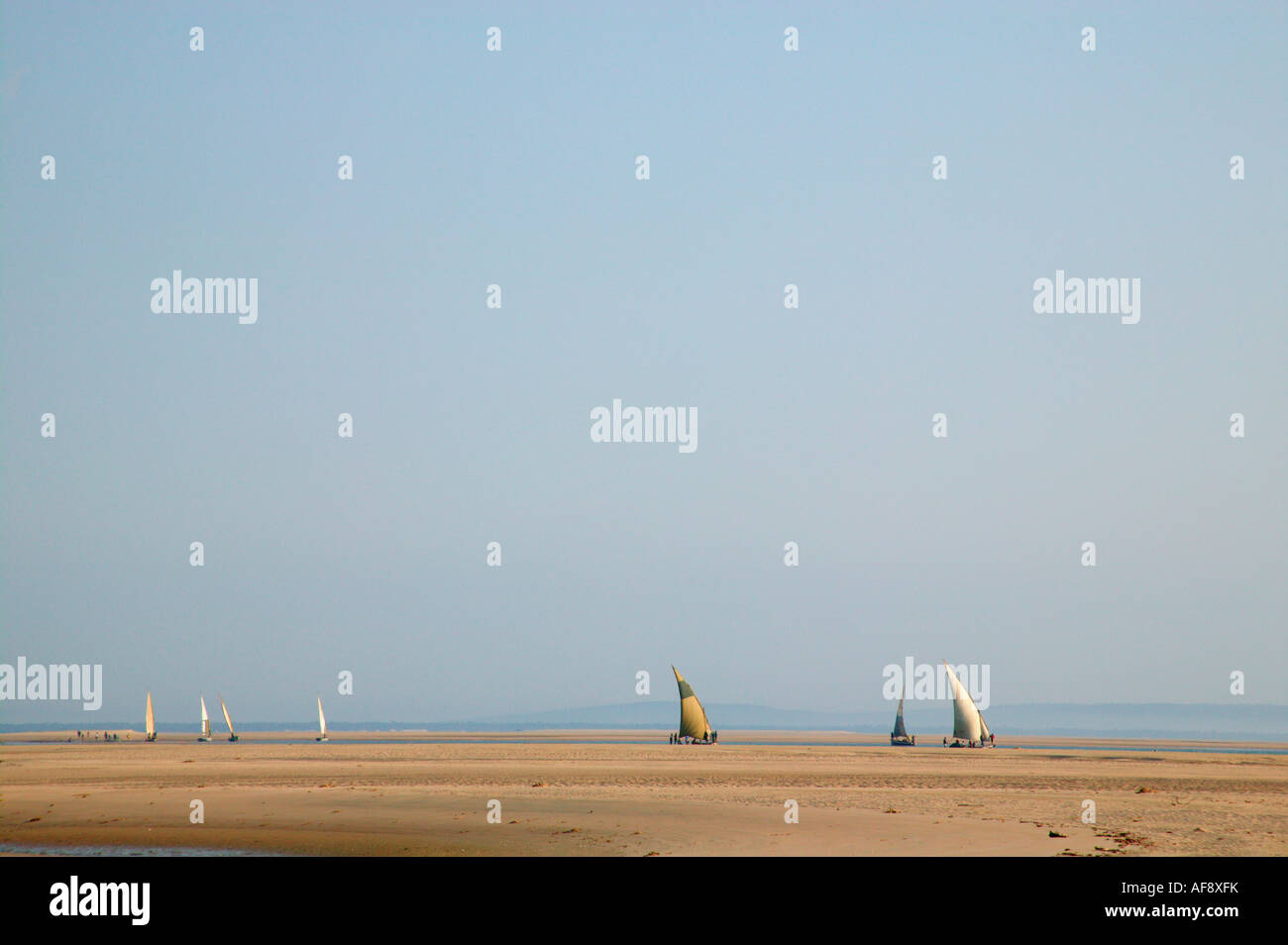 Dhows sailing down a narrow channel from Maxxixe towards the open sea Stock Photo