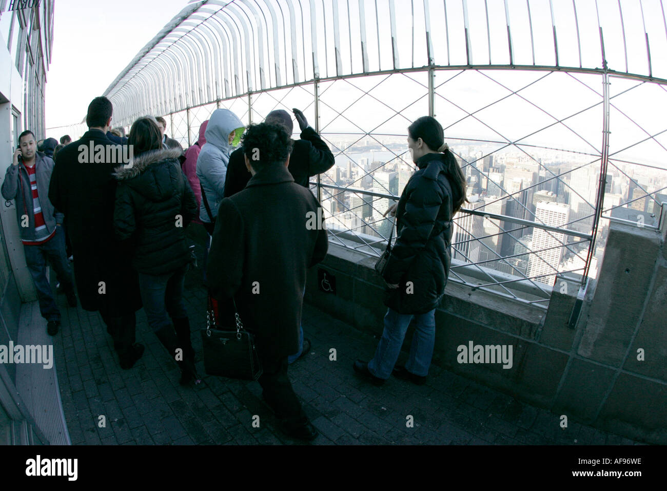 fisheye shot of sightseers look at the view from observation deck 86th floor near the top of the empire state building Stock Photo
