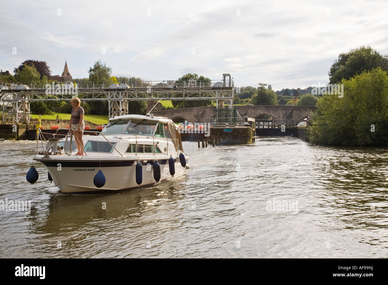 East Farleigh lock in background with passing motor boat along the