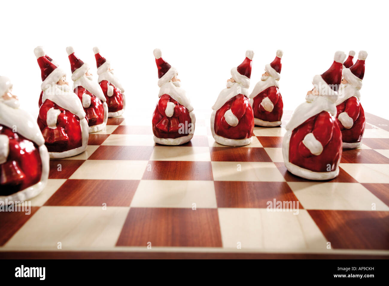 Santa Claus figurines standing on a chessboard Stock Photo
