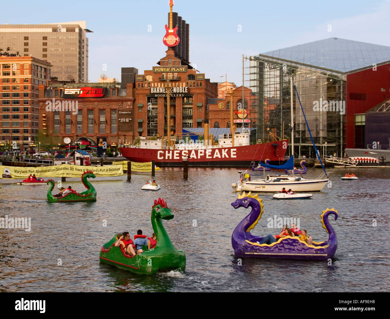 Children paddling colorful dragon boats in Baltimore's Inner Harbor