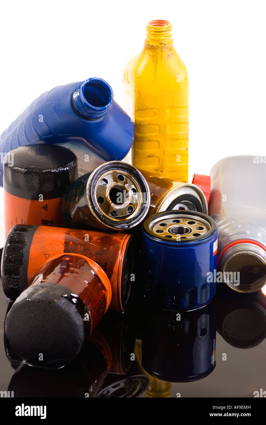 A pile of used oil filters and containers spilling on everything Where is your oil going Stock