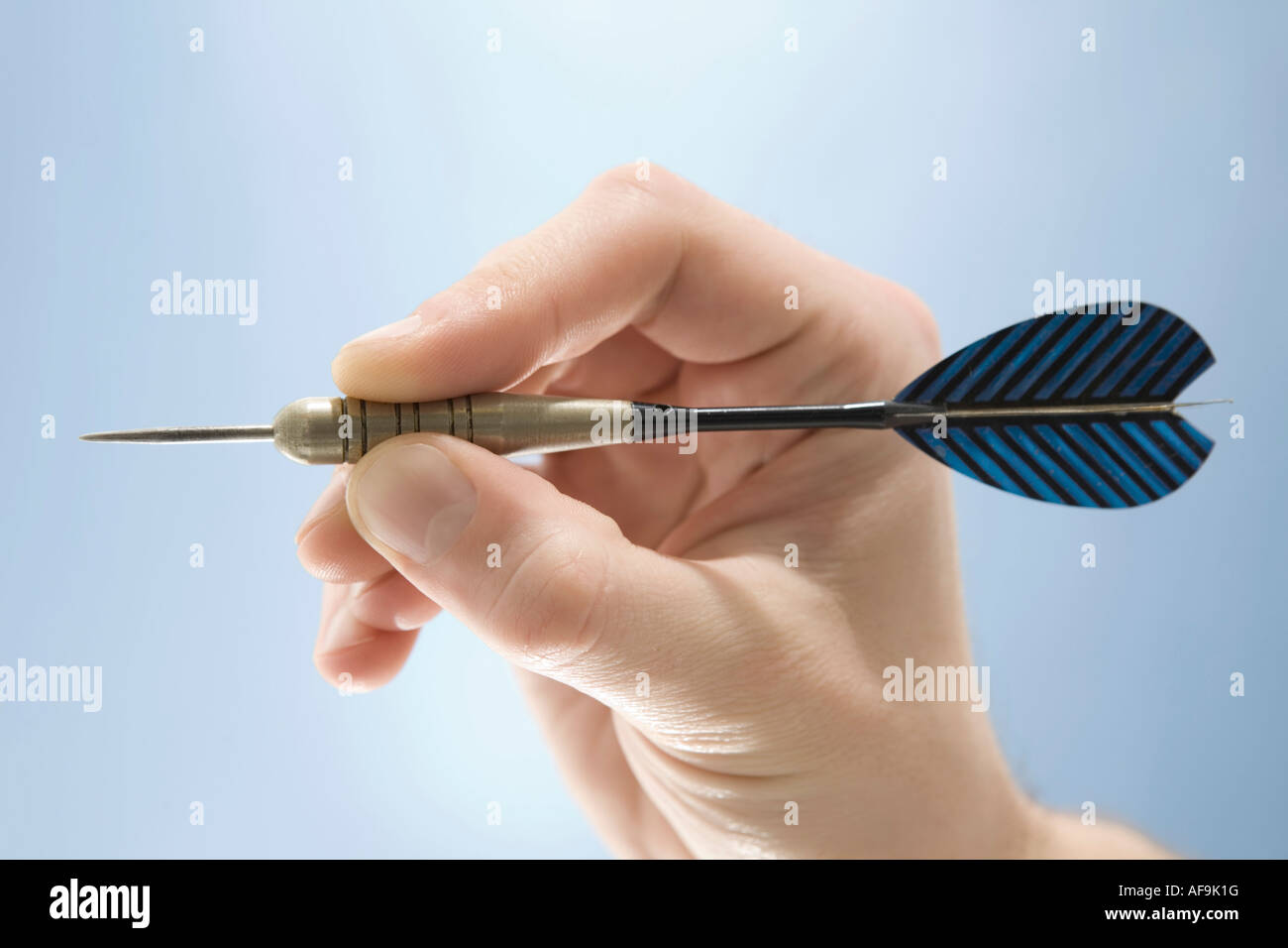 Hand holding dart, closeup Stock Photo Alamy