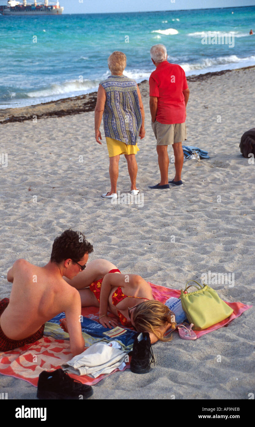 Miami Beach Florida,Atlantic Shore,shoreline,coast,coastline,seashore,young couple,adult adults man men male,woman women female lady,lying on towel,se Stock Photo