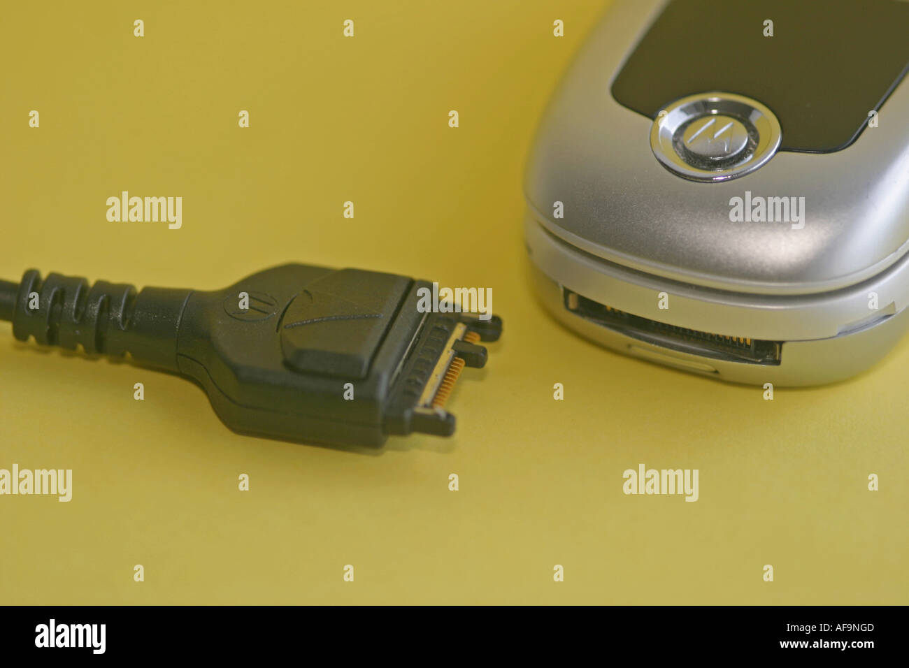 A Stock Photograph of a Mobile Phone and Wire Connecting to a Computer