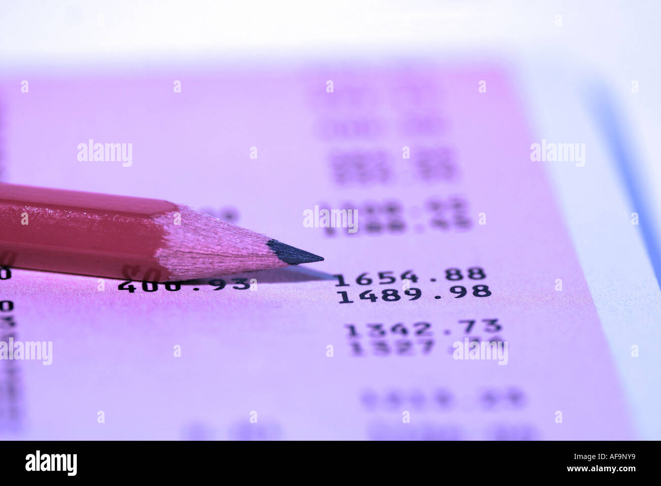 A Stock Photograph of A Pencil Next To Financial Figures Stock Photo