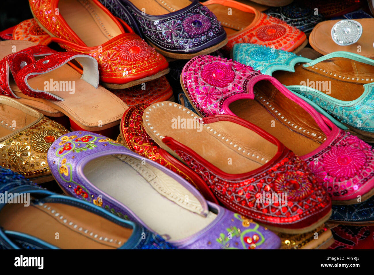 Colorful hand made Indian slippers for sale at an outdoor market Stock  Photo - Alamy