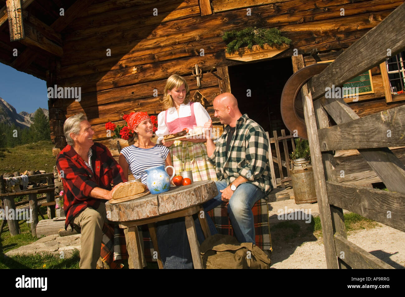 People having break in front of apine hut Stock Photo