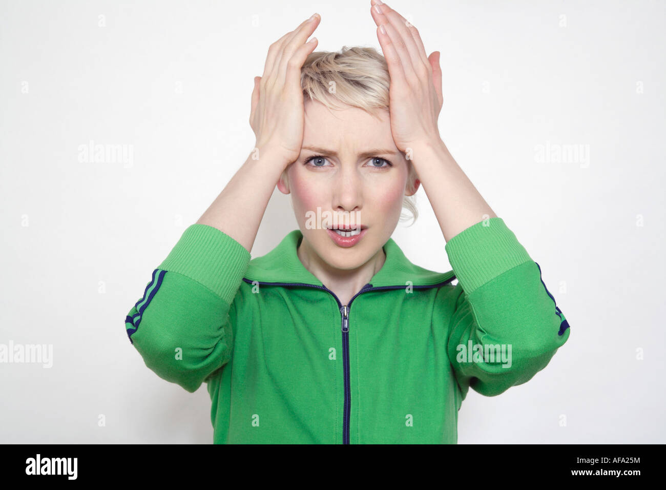 Young woman, hands on head Stock Photo