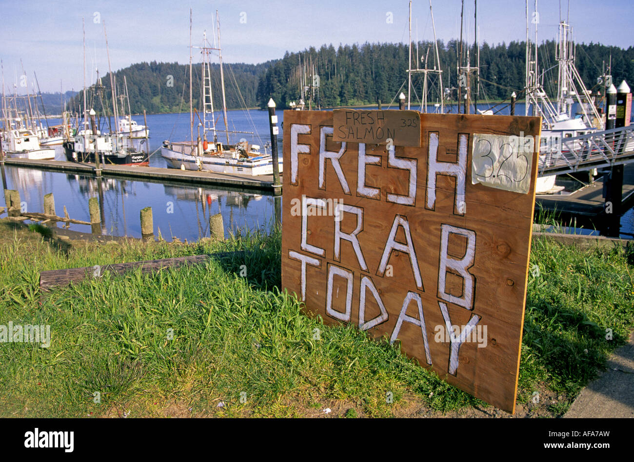 A Crab for Sale sign in the town of Florence and the Florence Harbor on the Oregon coa Stock Photo