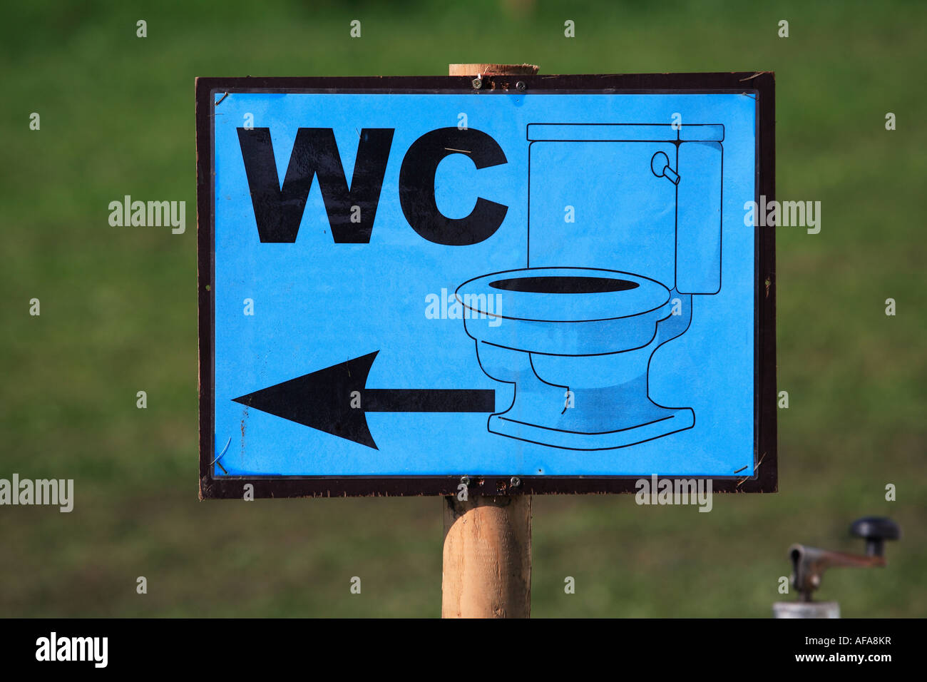 a blue sign pointing to a lavatory Stock Photo Alamy