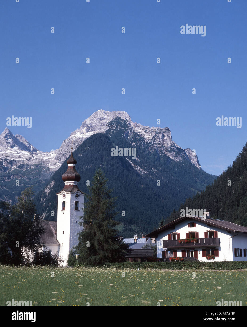 Our Lady of the Rosary Church and mountains, Lofer, Salzburg State, Republic of Austria Stock Photo