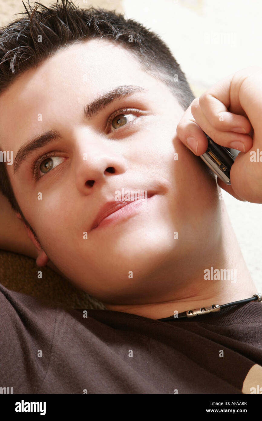 Teenage boy using mobile phone. Stock Photo