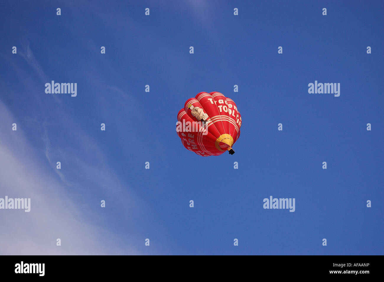 Red hot air balloon against a blue sky Stock Photo - Alamy