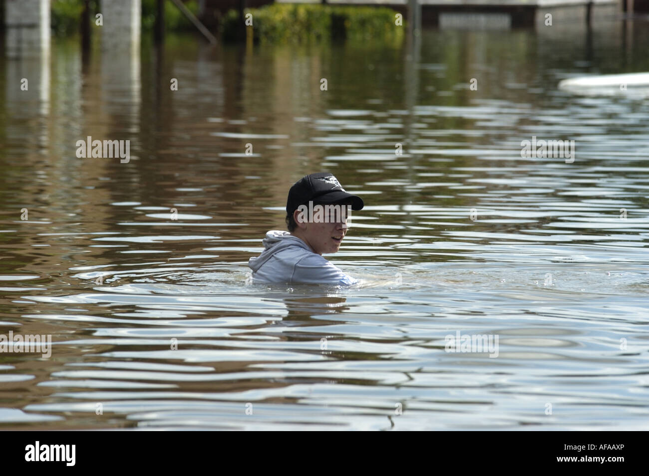 Child sits in flooded road in the Longford area of Gloucester England July 2007 Stock Photo