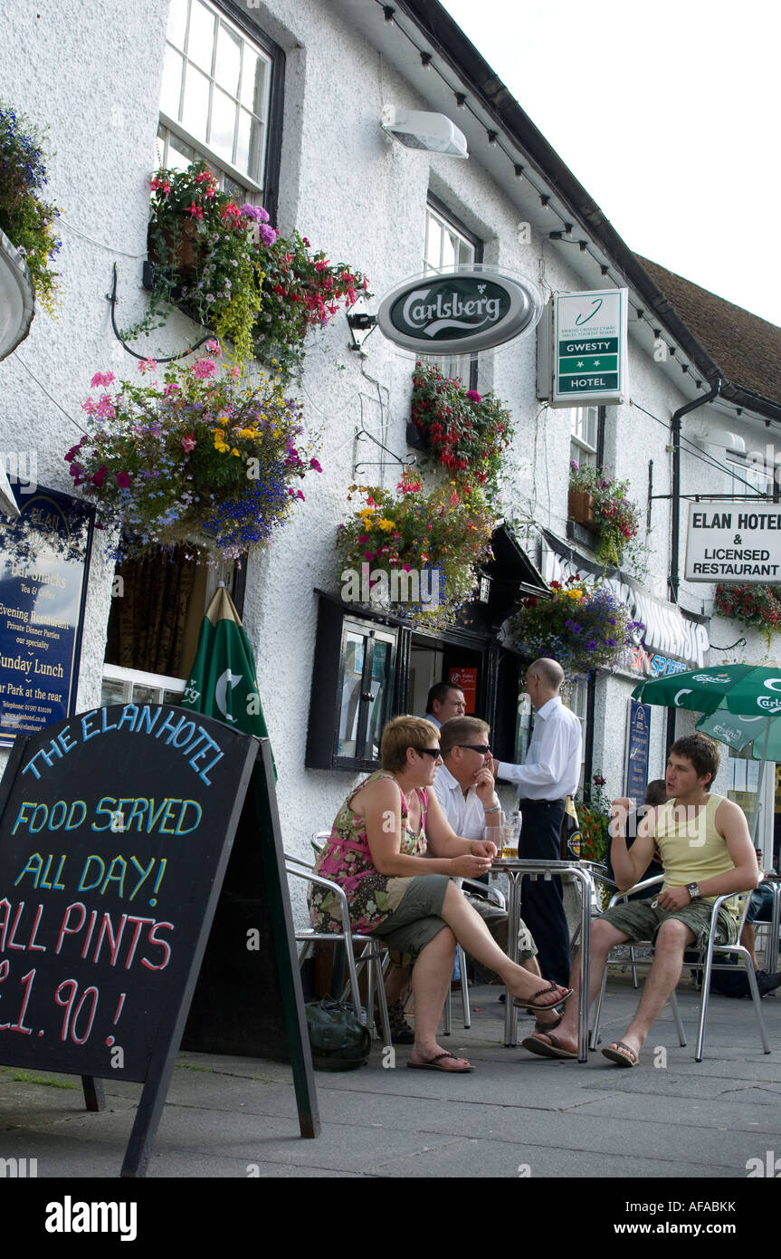 people on holiday enjoying  eating and drinking outside Elan Hotel exterior Rhayader Powys mid wales summer evening UK Stock Photo