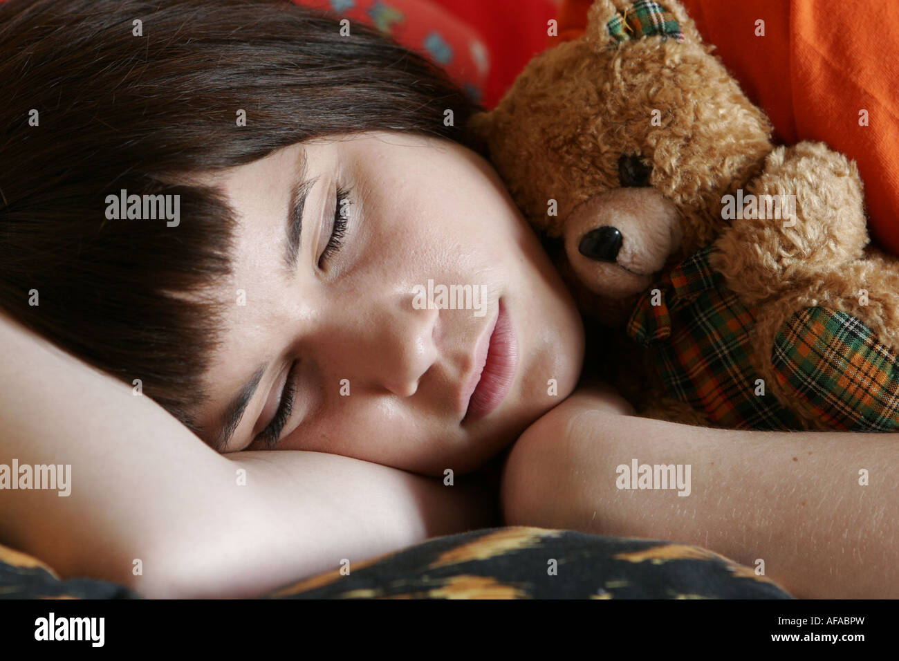 Teenager girl sleeping with teddy bear Stock Photo