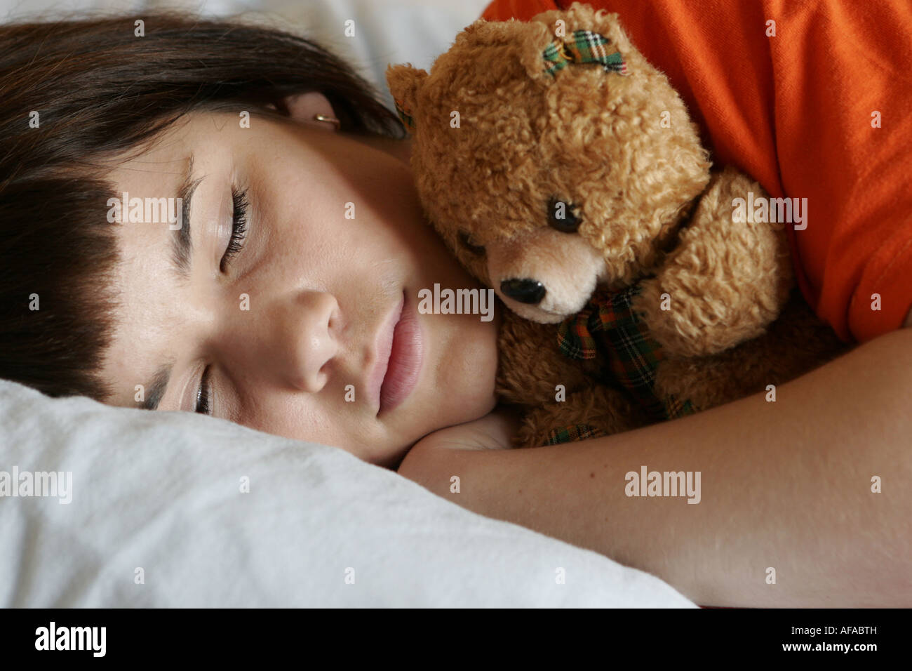 Teenager girl sleeping with teddy bear Stock Photo