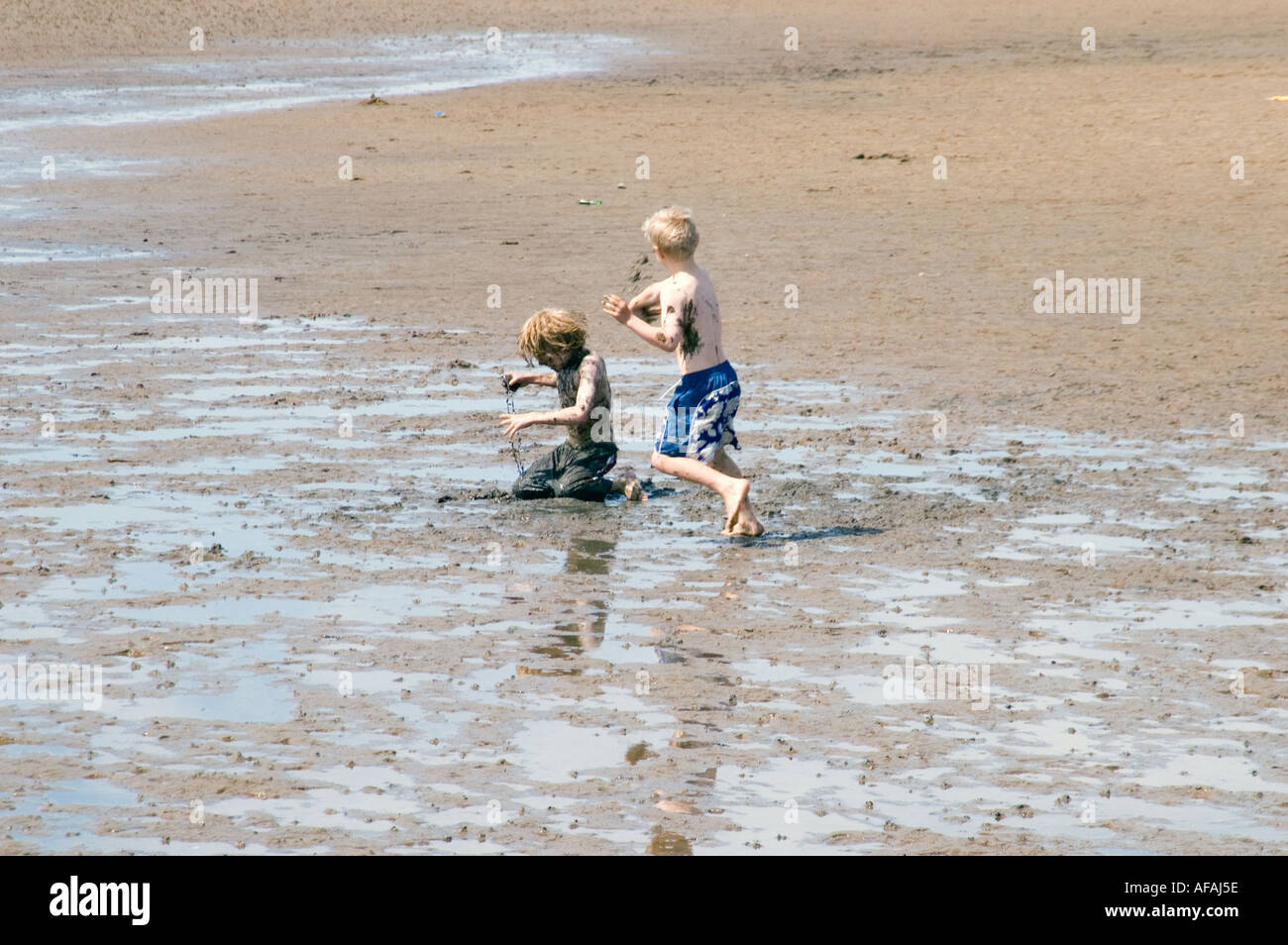 Children enjoying playing in the sands at West Kirby on the Wirral Stock Photo