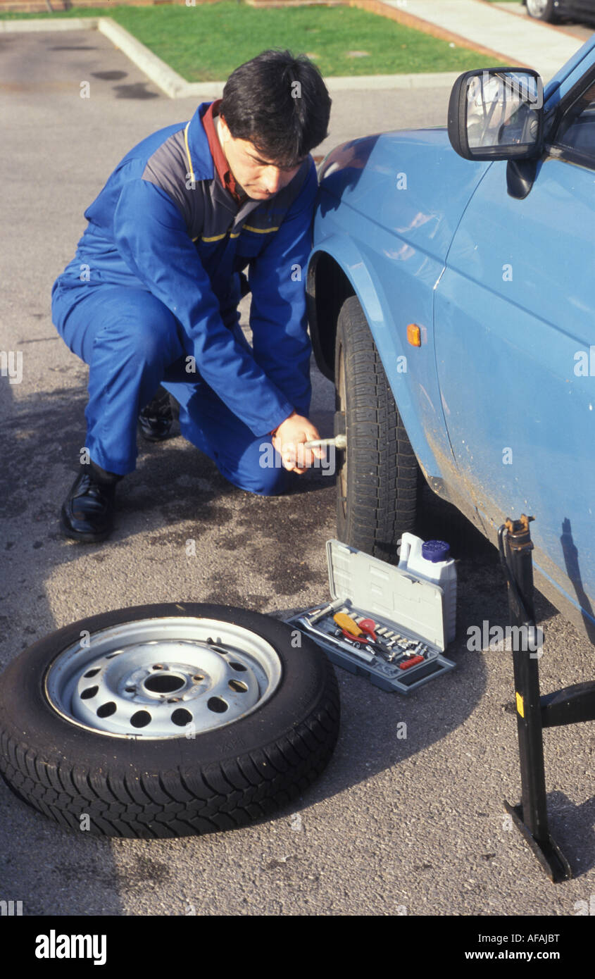 man changing the wheel of a car Stock Photo Alamy