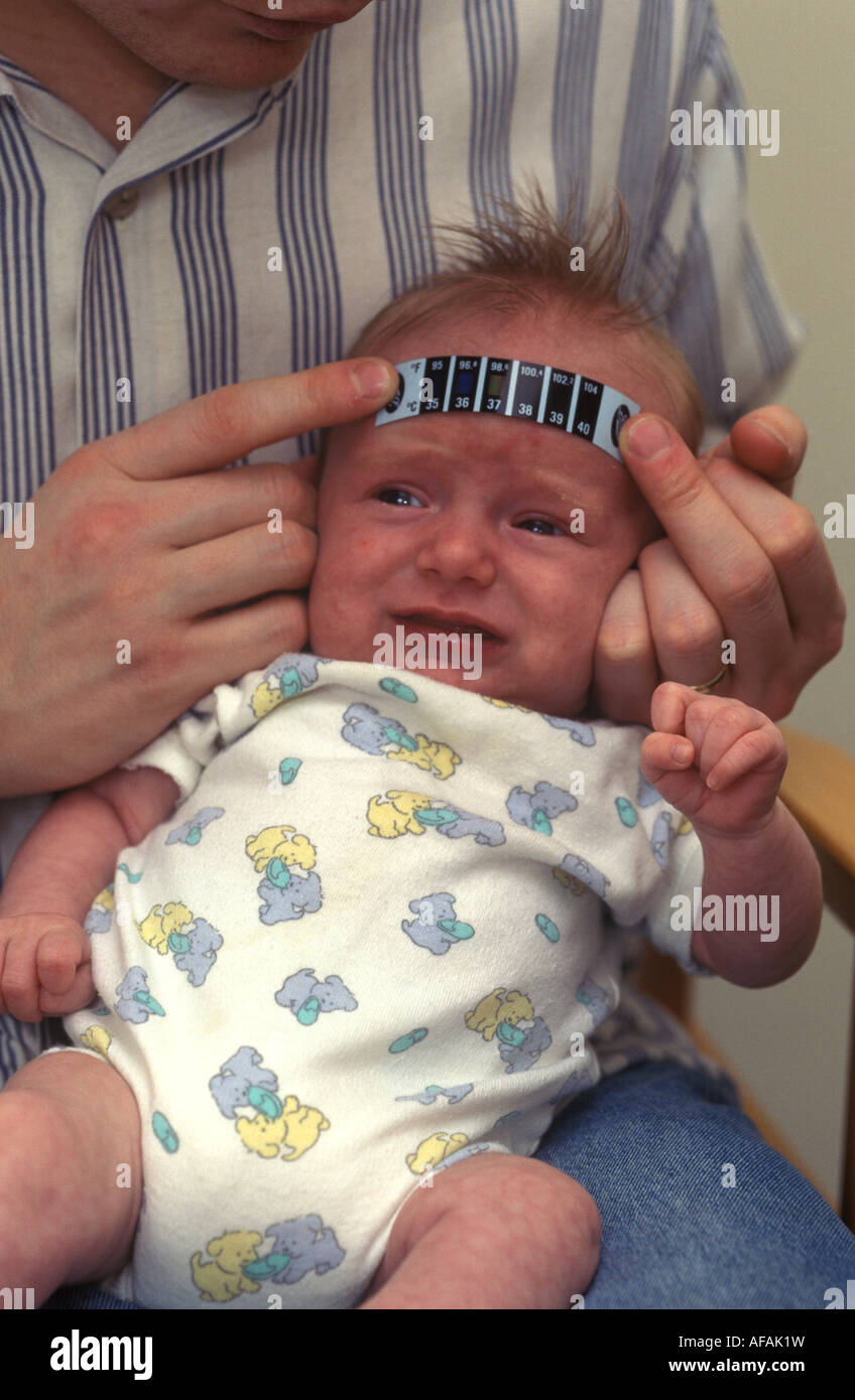 baby having his temperature taken using a thermometer strip Stock Photo
