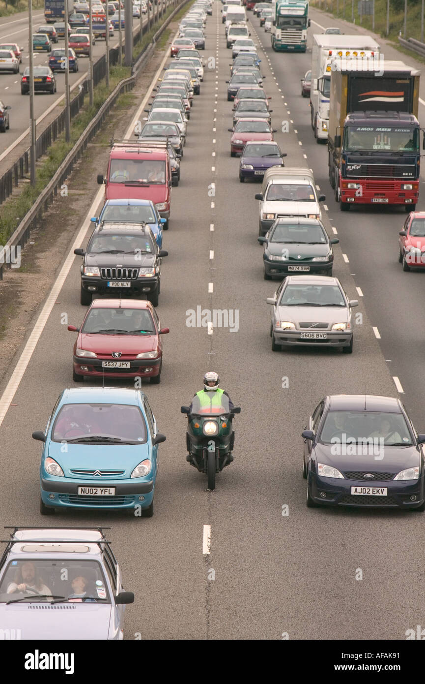 a motorbike between lanes of delayed traffic on the M1 motorway at Kegworth leicestershire UK Stock Photo