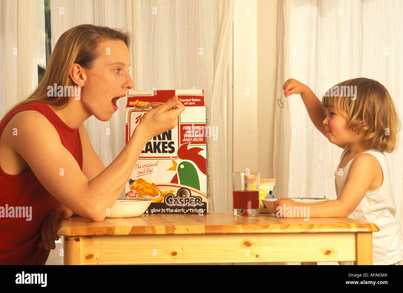 mother and toddler eating breakfast Stock Photo - Alamy