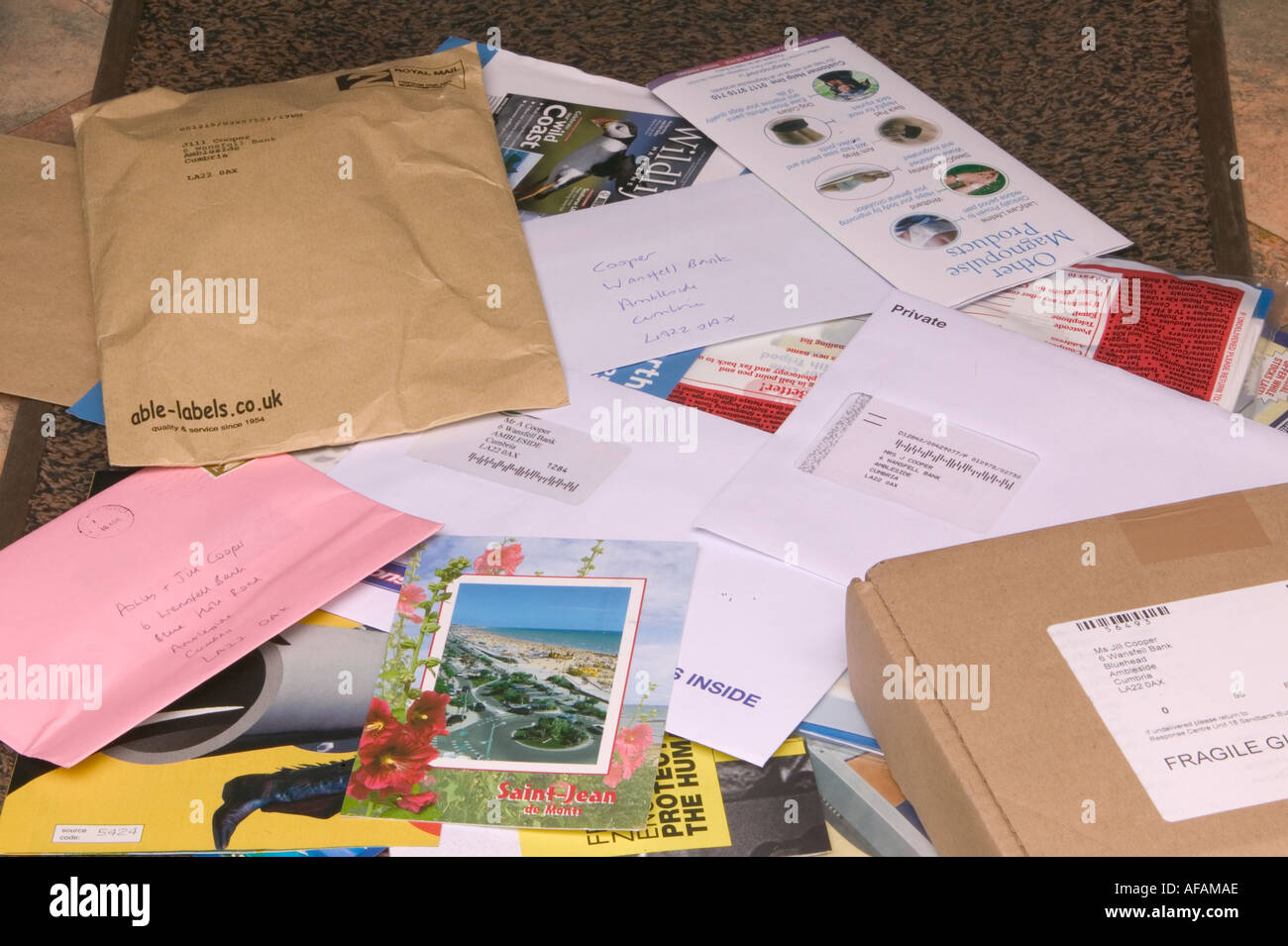 a mountain of post lying on a doormat having been pushed through the letterbox Stock Photo