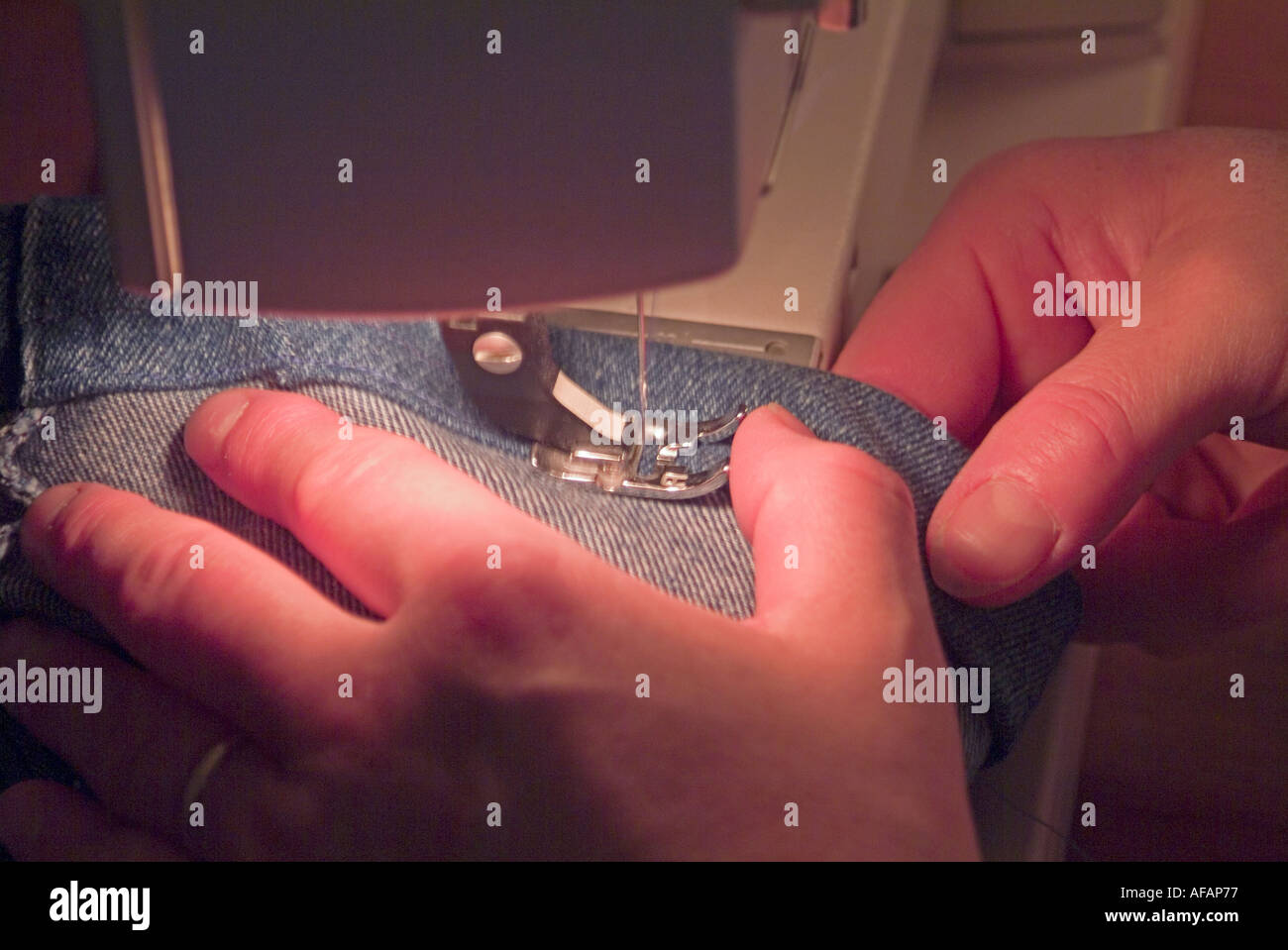 Hands sewing denim on a sewing machine Stock Photo Alamy