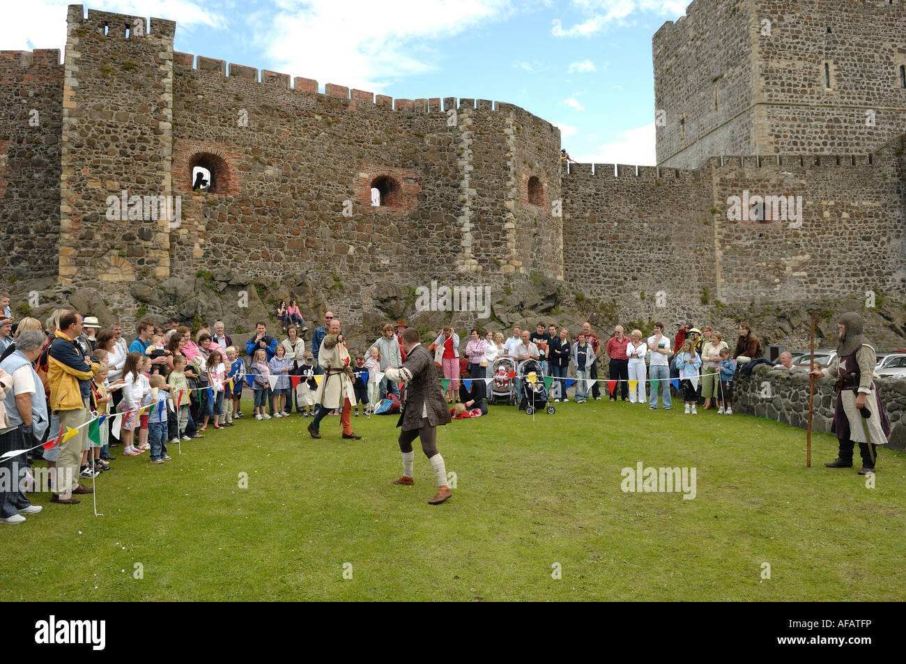 Re enactment of two medieval soldiers fight at Lughnasa Fair Carrickfergus Castle Stock Photo