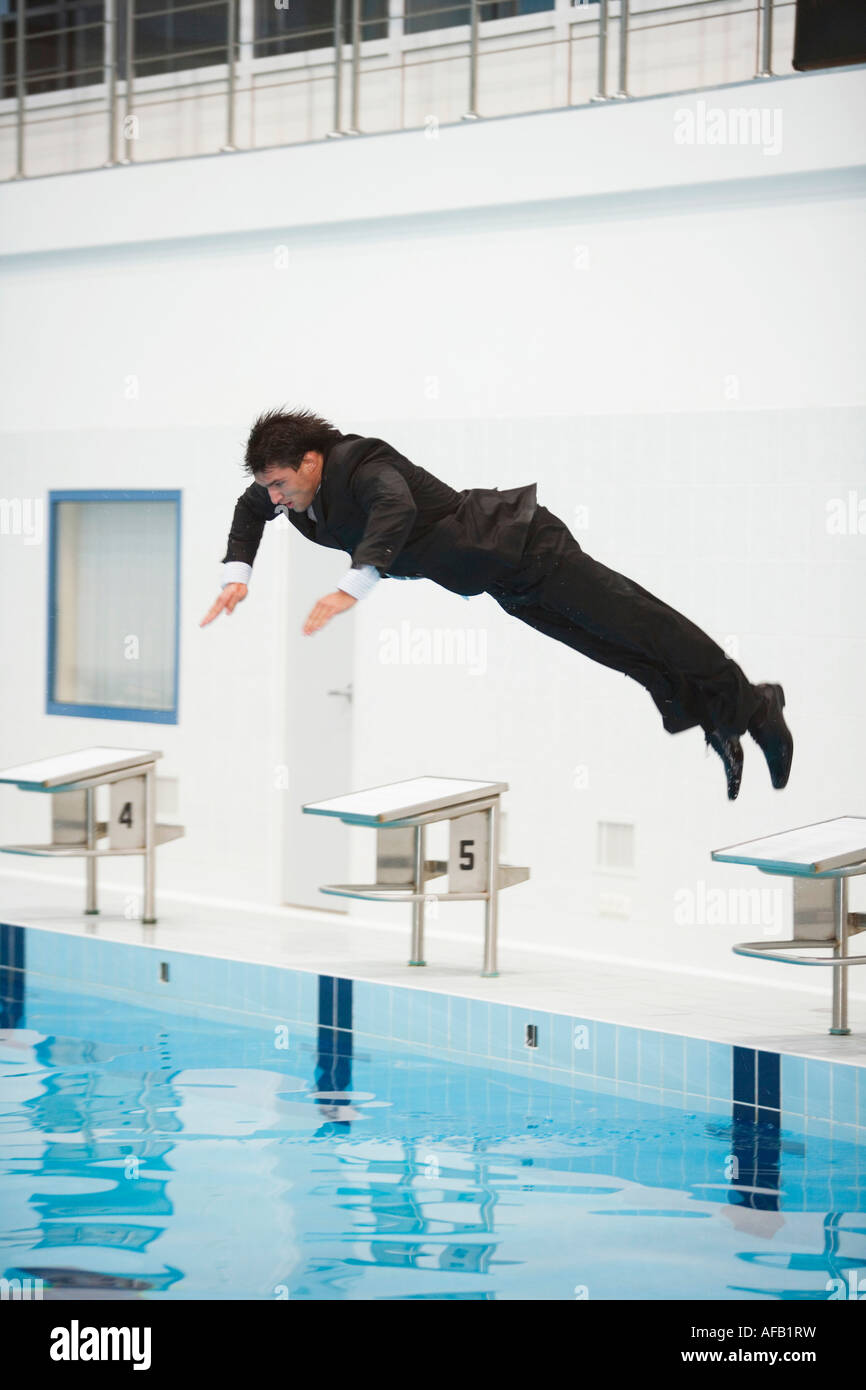 Businessman jumping in pool Stock Photo Alamy