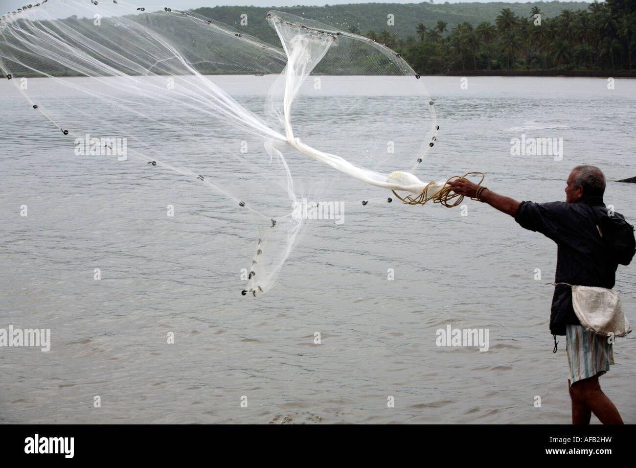 Fisherman casting net goa india hi-res stock photography and