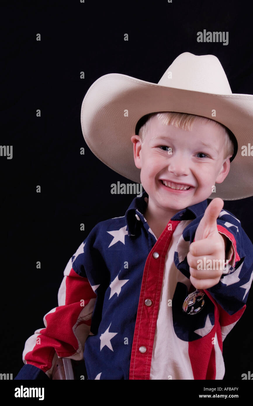 Adorable little five year old cowboy giving the thumbs up sign Stock Photo