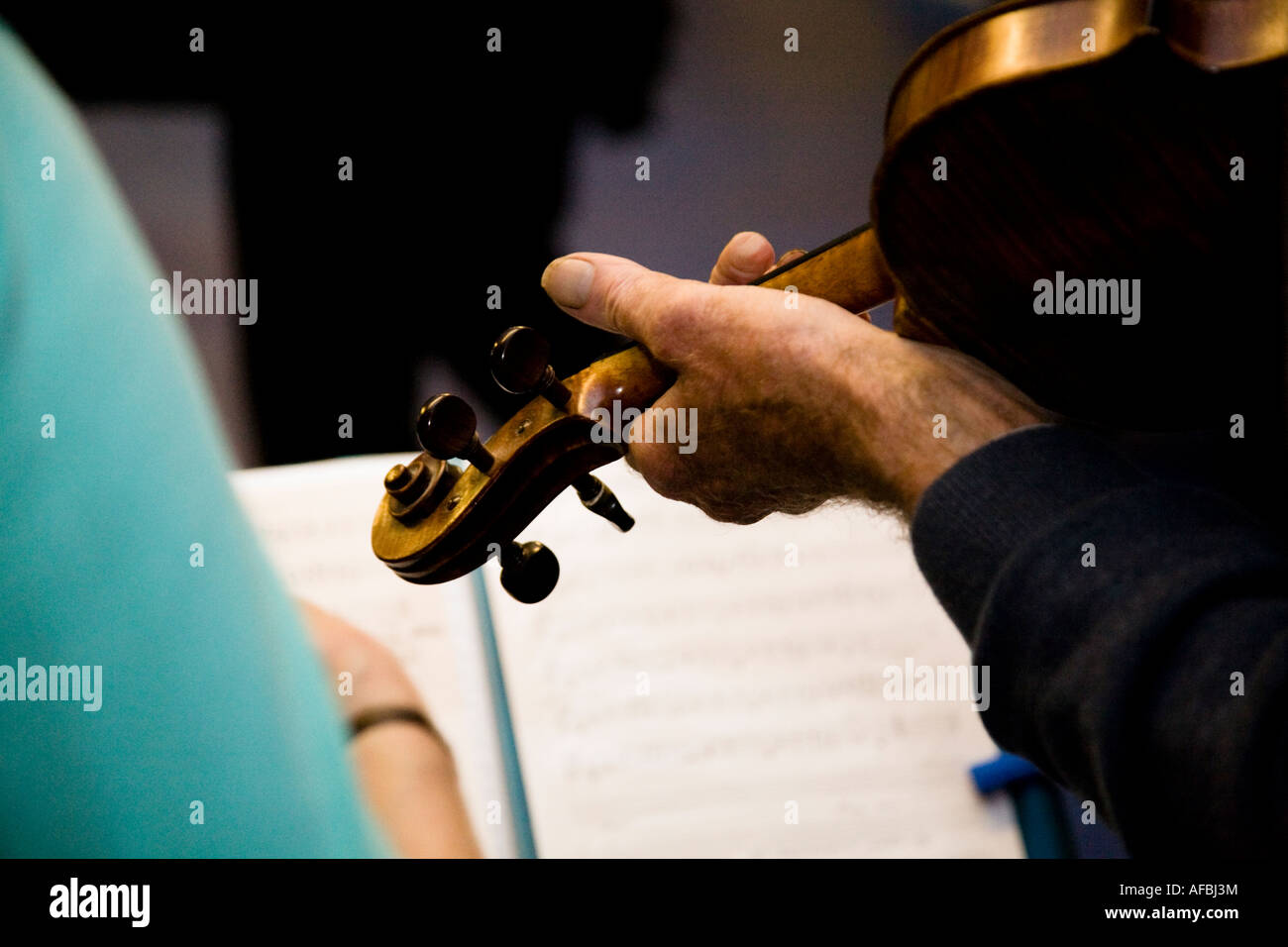 Fiddle being played by a folk musician during a folk dance Stock Photo