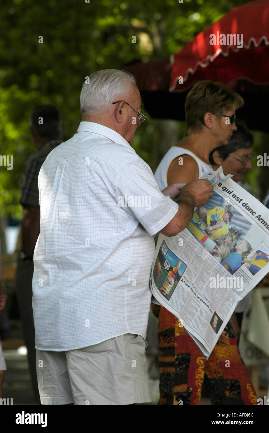 french man reading a news paper in a french market Stock Photo